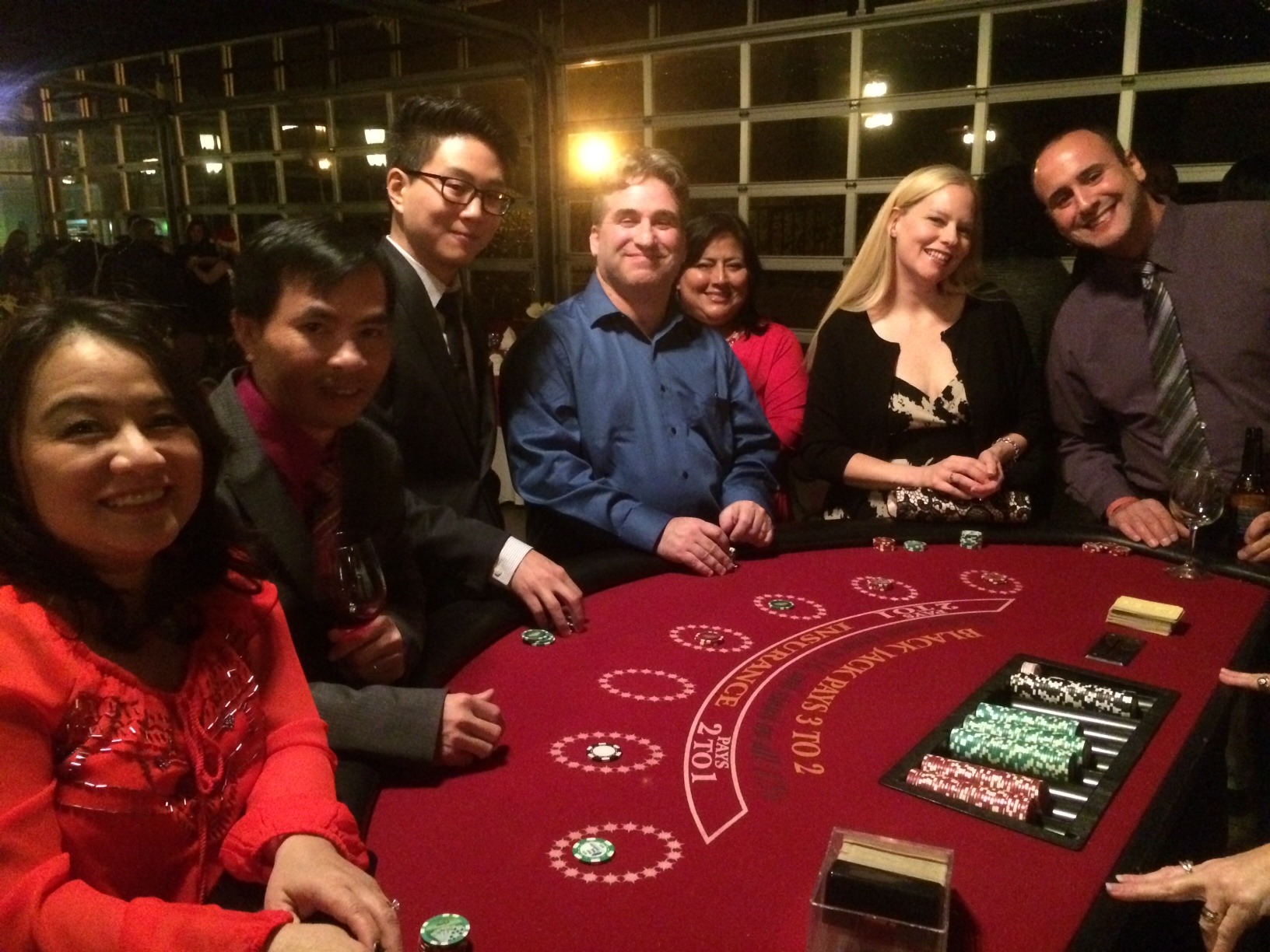 Blackjack Guests at a Red Casino Table - The Main Event Company A group of guests enjoying blackjack together at a red casino table
