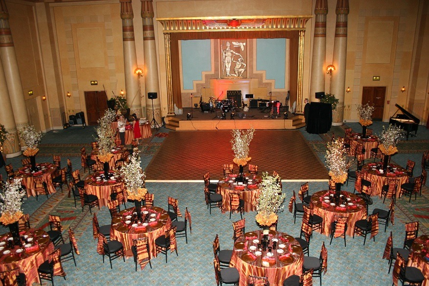 Custom Decor Elements - The Main Event Company Custom event decor with coordinated banquet tables, floral arrangements, and a stage