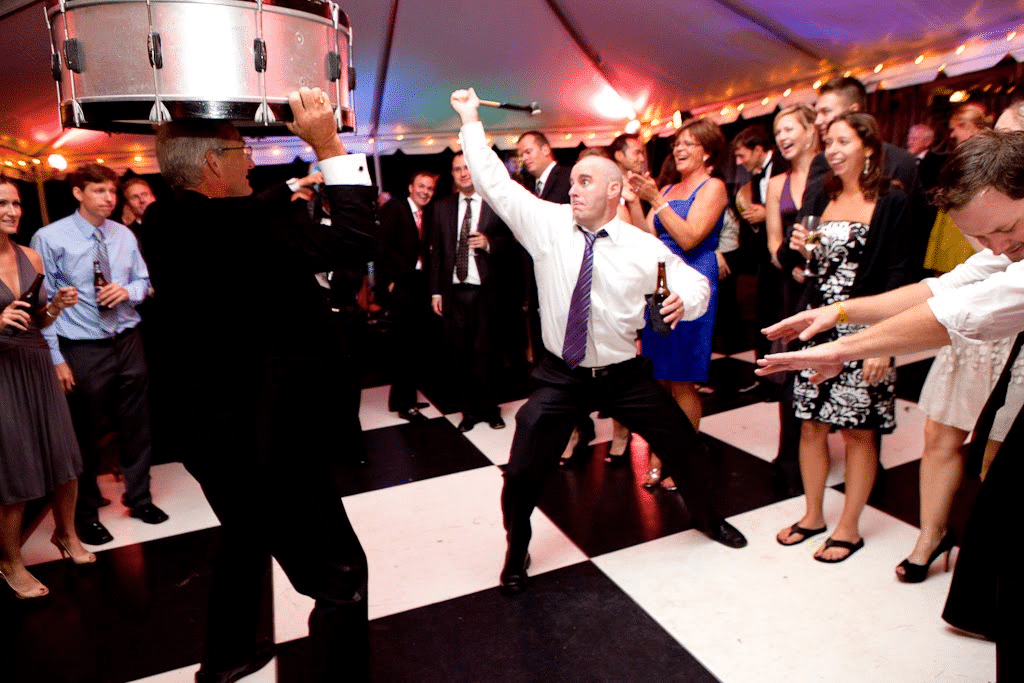 DJ Led Party on the Dance Floor - The Main Event Company A host and party guests enjoying music on an event dance floor
