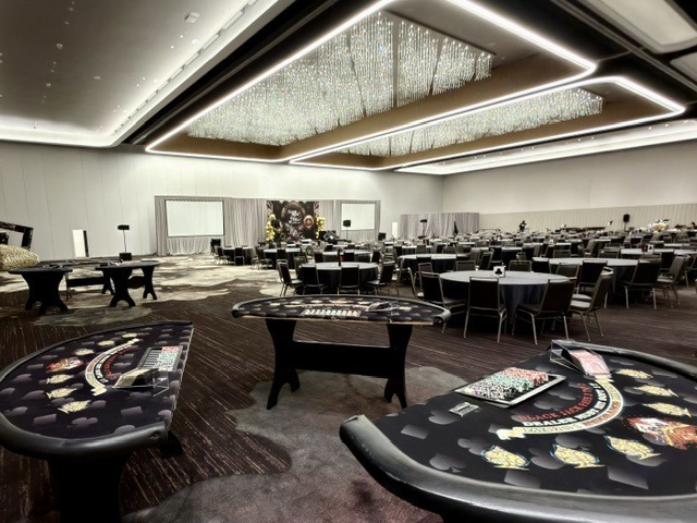 blackjack-table-rentals-modern-ballroom-banquet-setup - The Main Event Company Blackjack tables arranged beside banquet seating in a modern ballroom