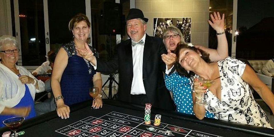 casino-night-guests-with-roulette-dealer - The Main Event Company Casino night guests and a professional dealer