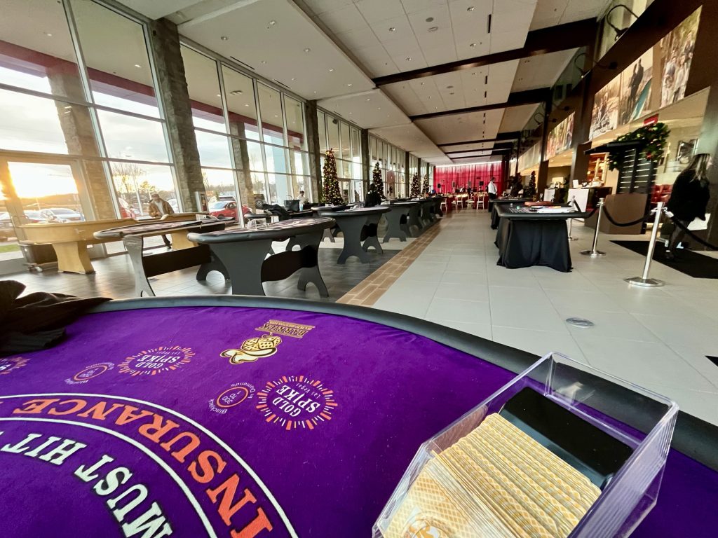 casino-tables-window-lined-event-room - The Main Event Company Casino table delivery and setup in an event venue