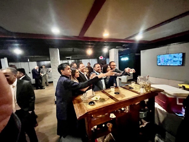 corporate events & teambuilding - The Main Event Company Event guests enjoying a shared activity at a wooden game table
