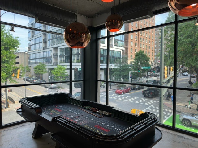 craps-table-rental-city-window-view - The Main Event Company Craps table arranged beside windows overlooking city buildings