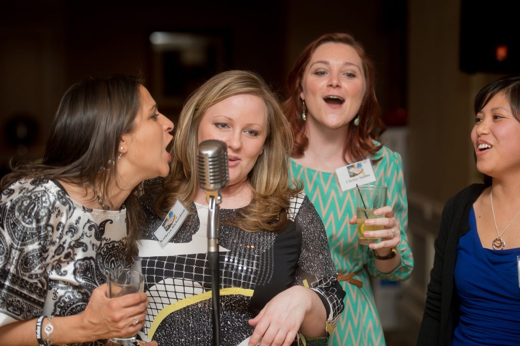 karaoke-party-guests-singing - The Main Event Company Party guests singing karaoke together