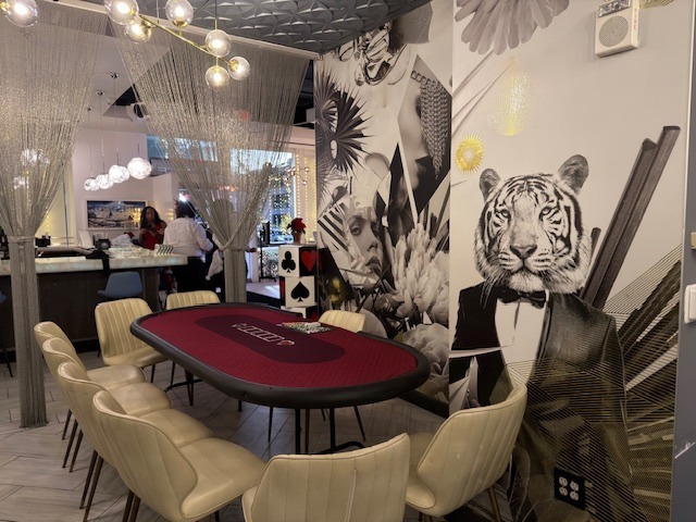Red poker table in an event room decorated with a tiger mural
